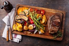 Club Beef steak and Grilled vegetables on cutting board on dark wooden background
